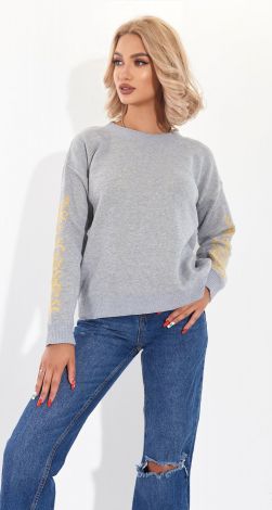 A beautiful sweater with an ornament on the sleeves