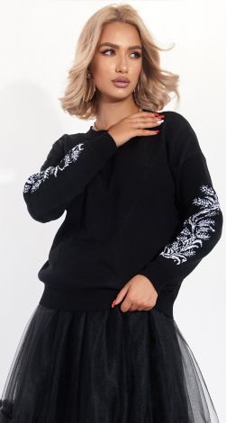 A beautiful sweater with an ornament on the sleeves