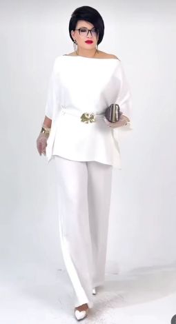 White pantsuit with an asymmetrical tunic blouse and belt