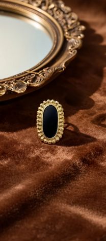 Massive gold-tone ring with a large black stone
