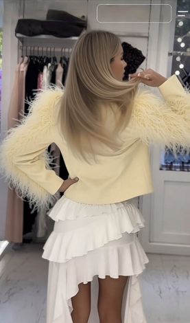 A luxurious cropped jacket with a full, voluminous ostrich feather boa
