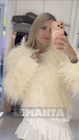 A luxurious cropped jacket with a full, voluminous ostrich feather boa