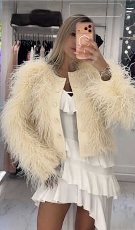 A luxurious cropped jacket with a full, voluminous ostrich feather boa
