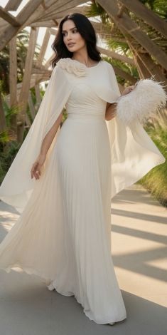 A luxurious off-white dress with a chiffon cape and voluminous roses