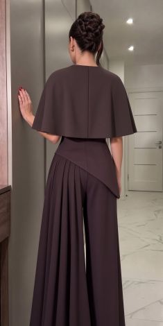 An exclusive deep chocolate-colored three-piece pantsuit with a cape