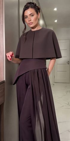 An exclusive deep chocolate-colored three-piece pantsuit with a cape