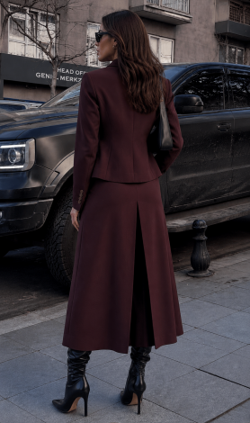 A brown suit in suiting fabric with a lined jacket and pleated skirt