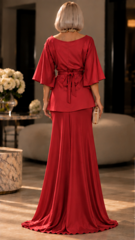 A red two-piece evening set in shimmering stretch fabric: a draped wrap blouse and a maxi skirt 